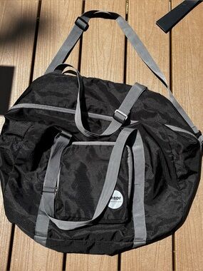 Black Foldable Duffel Bag with Gray Straps and Shoulder Strap